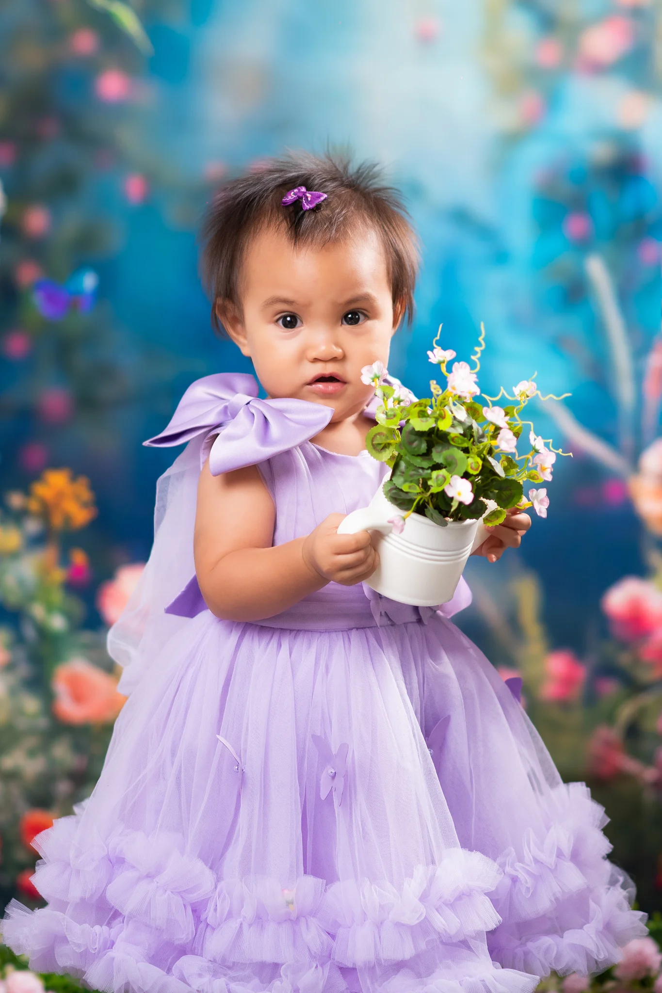 Julia holding a flower pot in her lavender dress