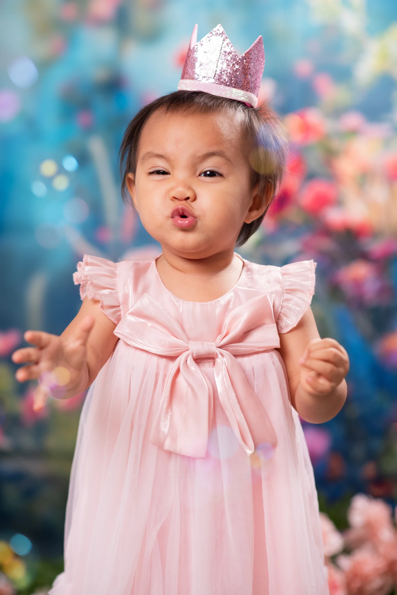 Julia wearing a crown and making a kiss face