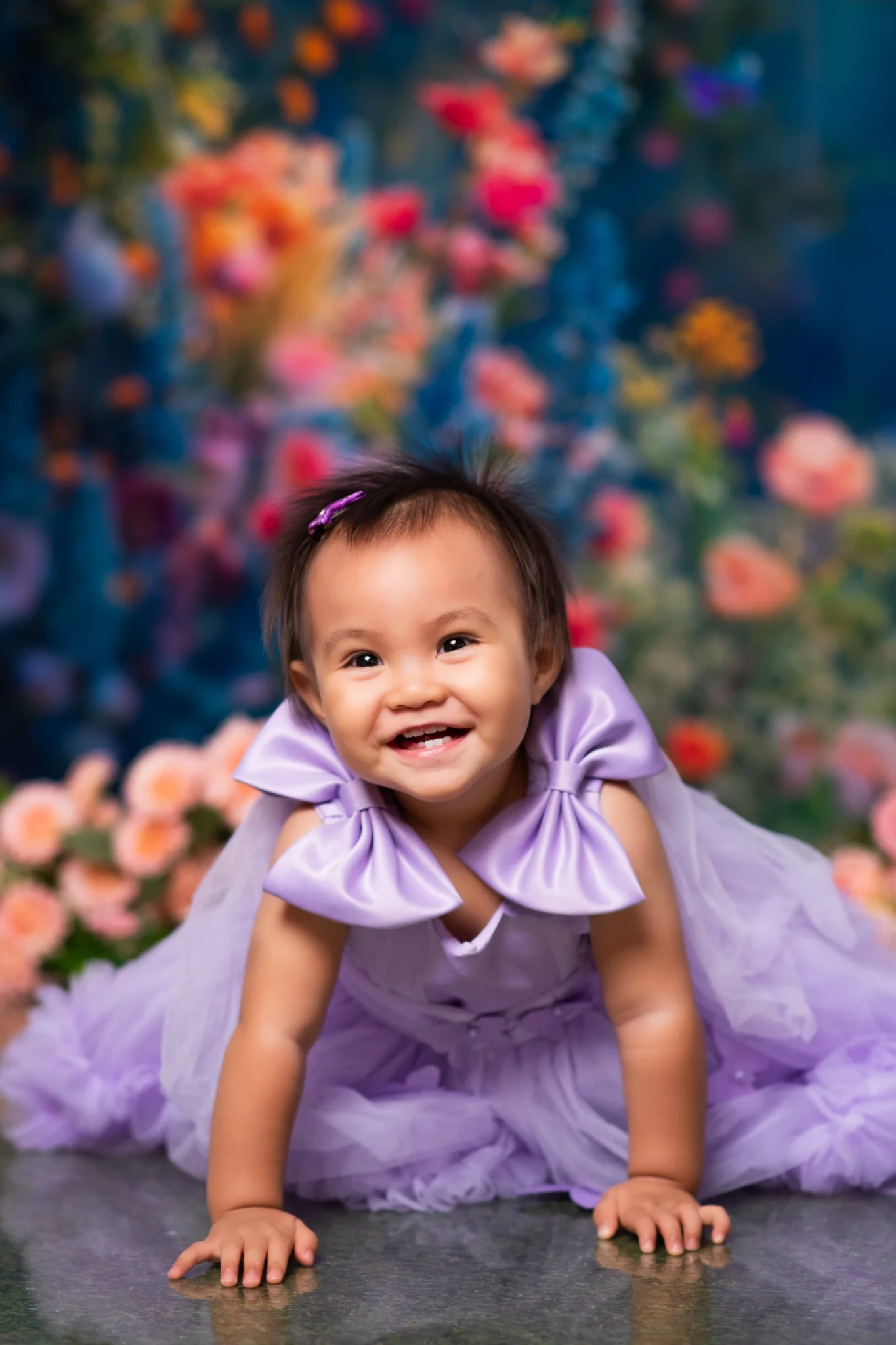 Julia smiling among flowers in her lavender dress